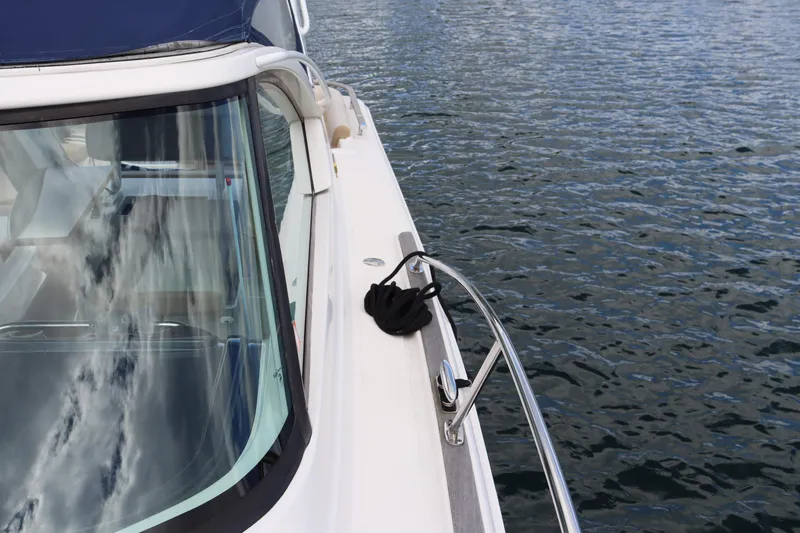 Cara Mia Yacht Photos Pics 2012 Tiara Yachts 3100 Coronet on calm water, showcasing sleek design and reflective windows.