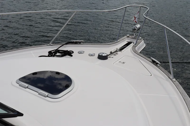 Cara Mia Yacht Photos Pics Bow of 2012 Tiara Yachts 3100 Coronet on water, featuring sleek design and railing.