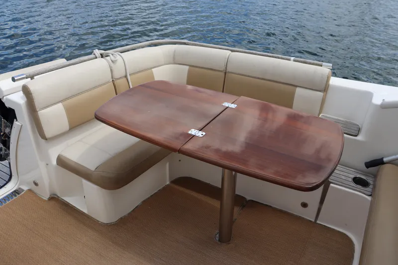 Cara Mia Yacht Photos Pics 2012 Tiara Yachts 3100 Coronet interior with cushioned seating and wooden table.