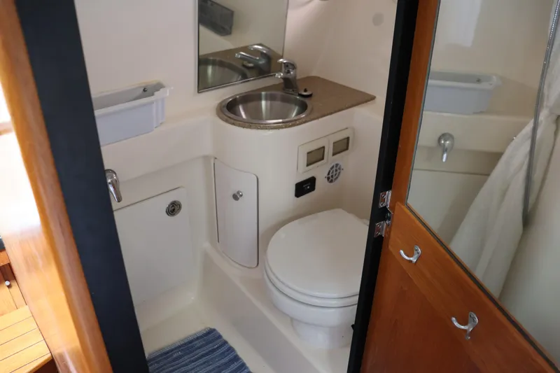 Cara Mia Yacht Photos Pics 2012 Tiara Yachts 3100 Coronet bathroom with sink, toilet, and mirror.