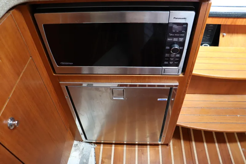 Cara Mia Yacht Photos Pics Microwave and fridge in 2012 Tiara Yachts 3100 Coronet galley, wood finish.