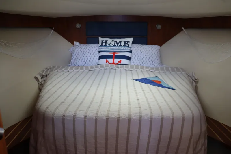 Cara Mia Yacht Photos Pics Cozy cabin interior of 2012 Tiara Yachts 3100 Coronet with nautical-themed bedding.