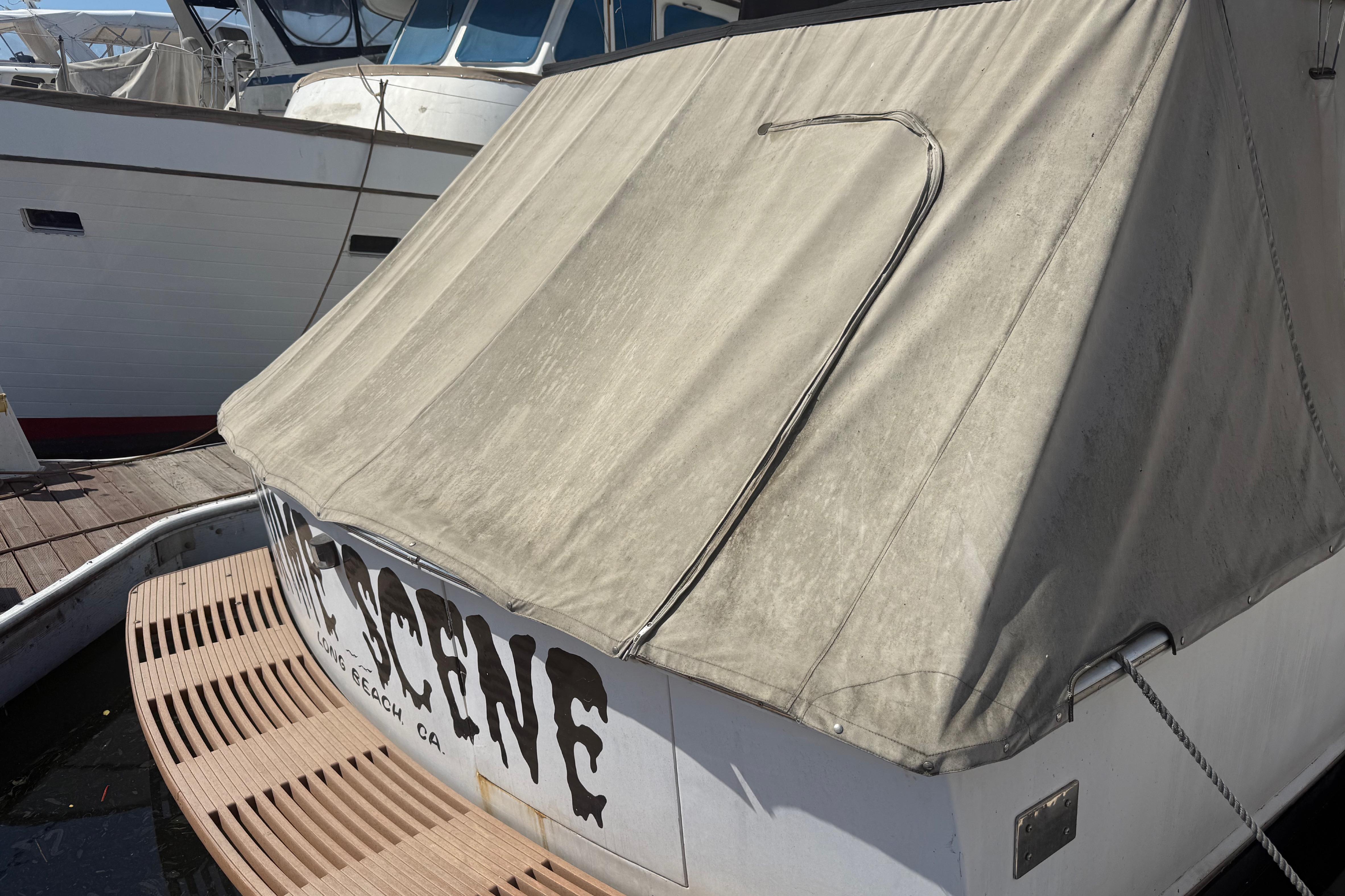 1974 Pacemaker 48 Sportfisherman boat docked with canvas cover, Long Beach, CA.