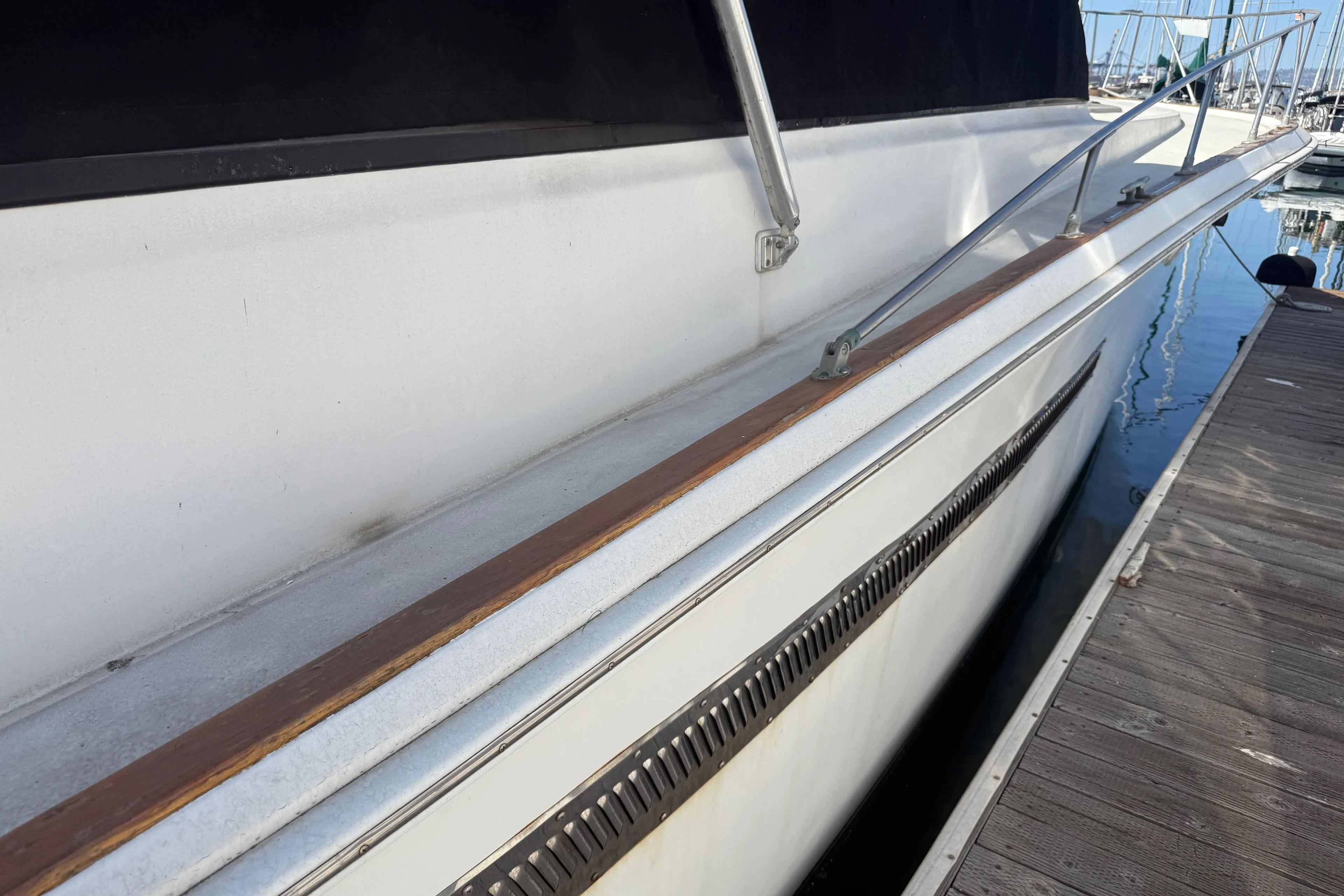 1974 Pacemaker 48 Sportfisherman yacht docked, showcasing sleek side view and railing.