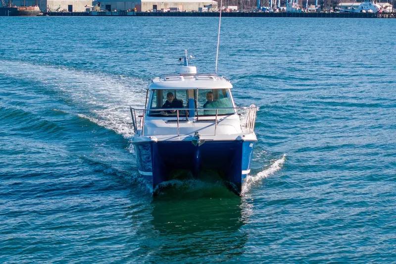  Yacht Photos Pics Aspen C90 2012 boat cruising on blue water near industrial docks.