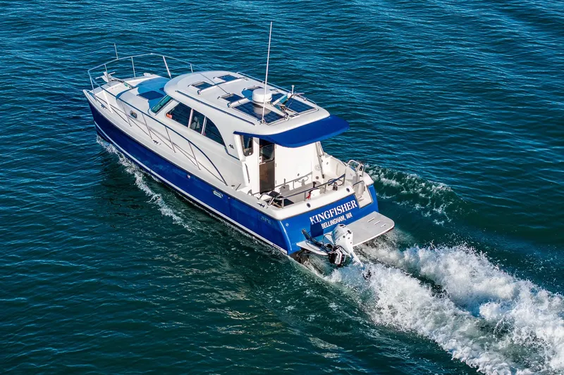  Yacht Photos Pics 2012 Aspen C90 boat cruising on open water, rear view.