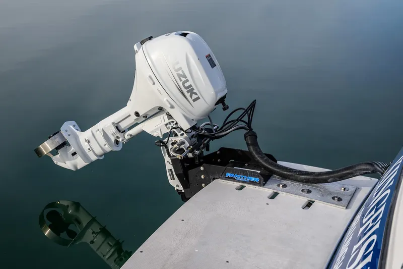  Yacht Photos Pics Outboard motor on Aspen C90 boat, 2012 model, reflected in calm water.