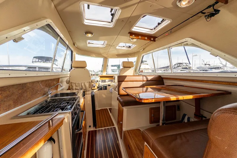  Yacht Photos Pics Luxurious interior of 2012 Aspen C90 yacht with dining area and kitchenette.