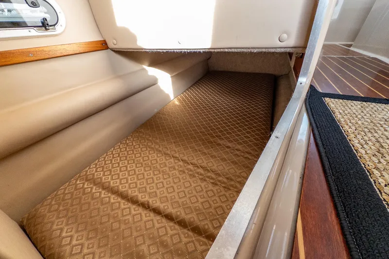  Yacht Photos Pics 2012 Aspen C90 interior cabin with cushioned sleeping area and wooden accents.
