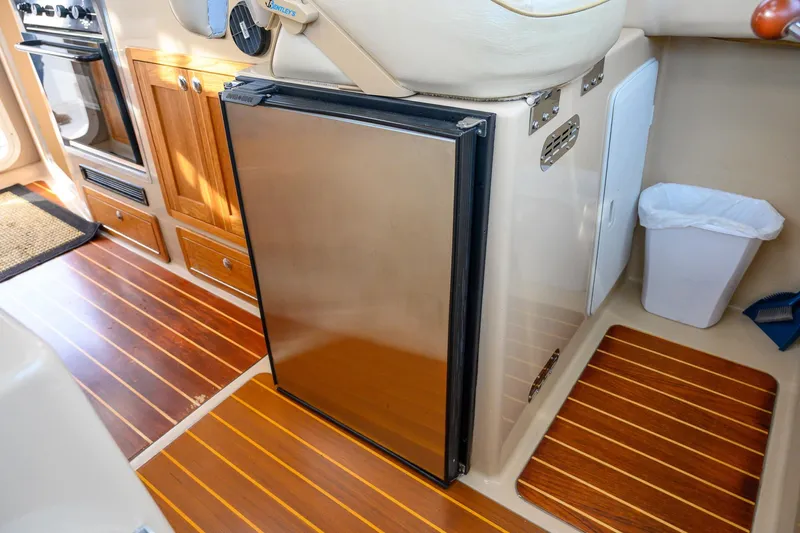  Yacht Photos Pics Interior of 2012 Aspen C90 boat with wooden flooring and compact kitchen area.