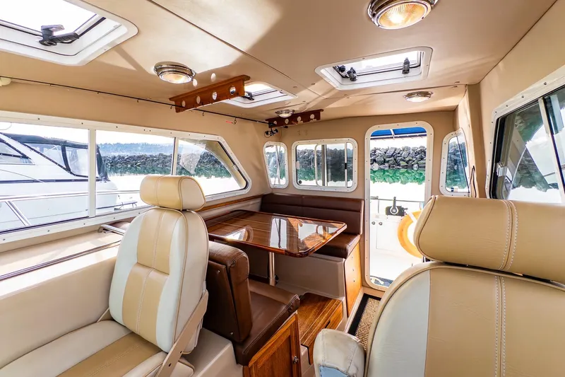  Yacht Photos Pics Luxurious interior of 2012 Aspen C90 boat with leather seating and wooden table.