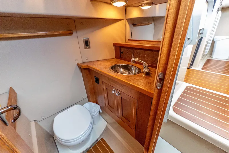  Yacht Photos Pics Aspen C90 2012 boat bathroom with wooden cabinetry and compact design.