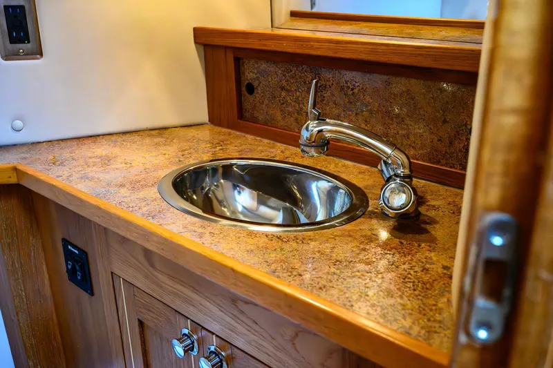  Yacht Photos Pics 2012 Aspen C90 interior sink with chrome faucet and wood cabinetry.