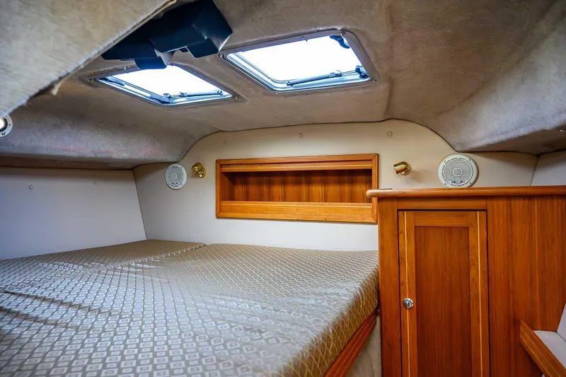  Yacht Photos Pics Cozy cabin interior of 2012 Aspen C90 boat with wood accents and skylights.