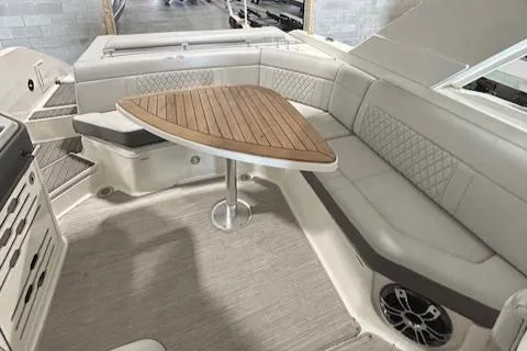  Yacht Photos Pics 2021 Sea Ray SLX 310 interior with elegant seating and wooden table.