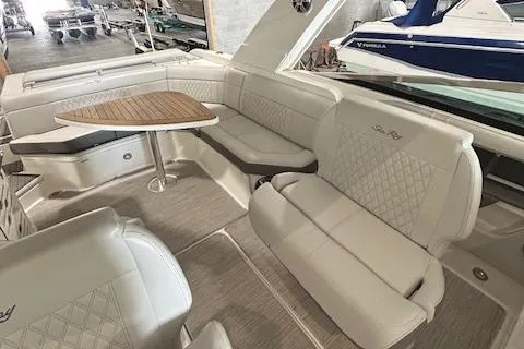  Yacht Photos Pics Luxurious interior of 2021 Sea Ray SLX 310 boat with elegant seating and table.