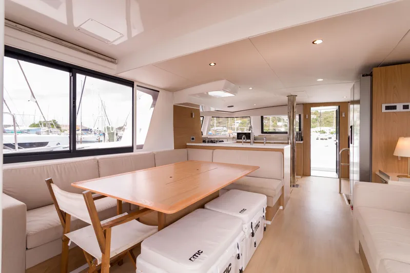 Tikka Yacht Photos Pics Modern interior of 2024 Bali 4.6 yacht with spacious dining area and large windows.