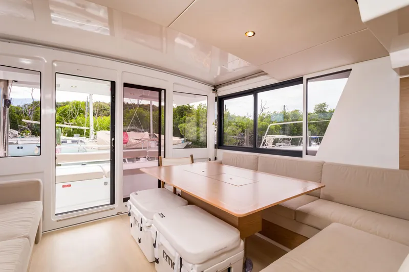 Tikka Yacht Photos Pics Spacious interior of 2024 Bali 4.6 yacht with modern seating and large windows.