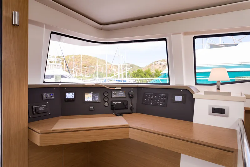 Tikka Yacht Photos Pics Interior view of 2024 Bali 4.6 yacht cockpit with navigation controls and panoramic windows.