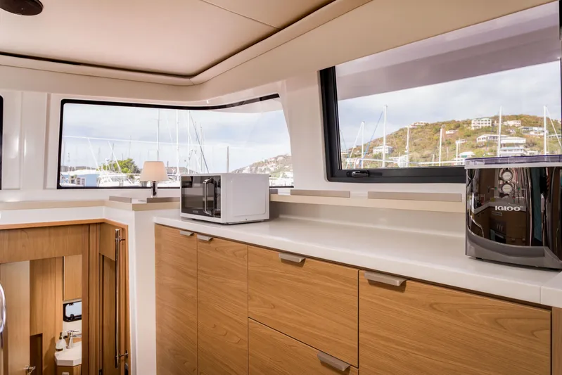 Tikka Yacht Photos Pics Modern kitchen interior on 2024 Bali 4.6 yacht with wooden cabinets and appliances.