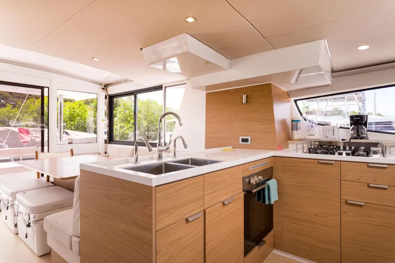 Tikka Yacht Photos Pics Modern kitchen interior on 2024 Bali 4.6 yacht with wood cabinetry and dual sinks.