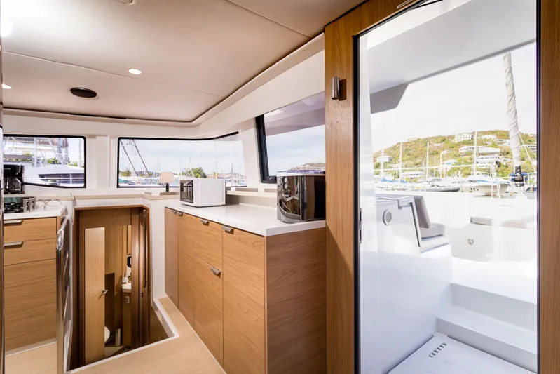Tikka Yacht Photos Pics Modern interior of 2024 Bali 4.6 yacht with sleek kitchen and outdoor view.