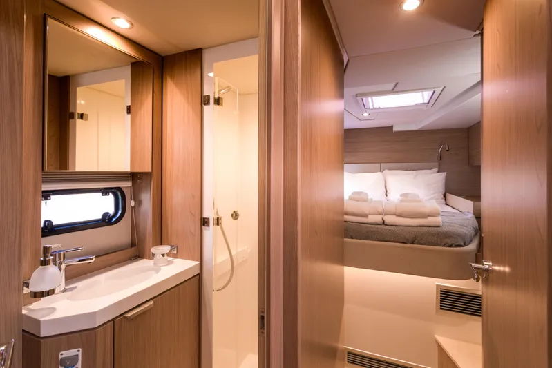 Tikka Yacht Photos Pics Luxurious interior of 2024 Bali 4.6 yacht featuring bedroom and bathroom.