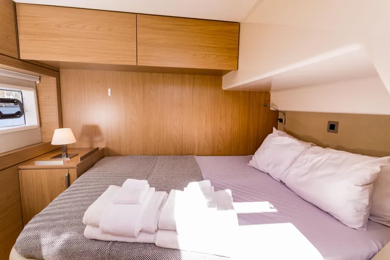 Tikka Yacht Photos Pics Luxurious bedroom in 2024 Bali 4.6 yacht with cozy bedding and natural light.