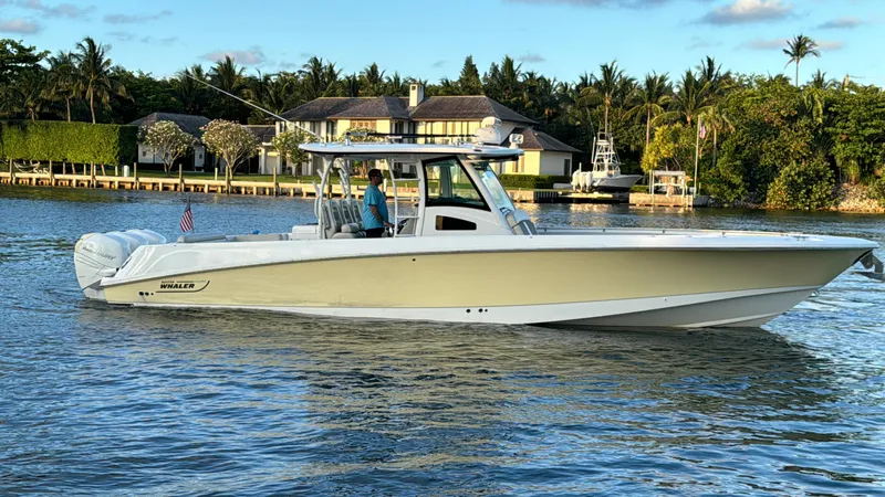  Yacht Photos Pics 2017 Boston Whaler 370 Outrage boat cruising on a scenic waterway.