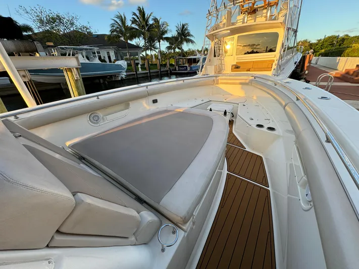  Yacht Photos Pics 2017 Boston Whaler 370 Outrage boat with spacious deck and seating area, docked near palm trees.