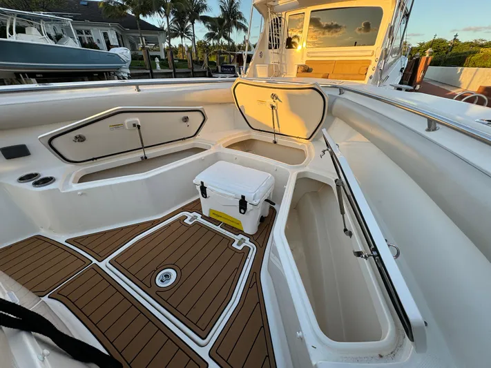  Yacht Photos Pics 2017 Boston Whaler 370 Outrage boat interior with open storage compartments and cooler.
