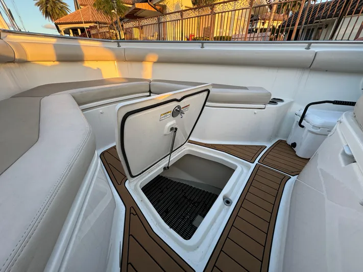  Yacht Photos Pics 2017 Boston Whaler 370 Outrage interior with open storage compartment and cushioned seating.