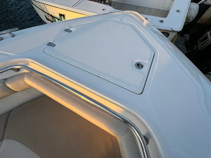  Yacht Photos Pics 2017 Boston Whaler 370 Outrage boat deck with cushioned seating and storage compartment.