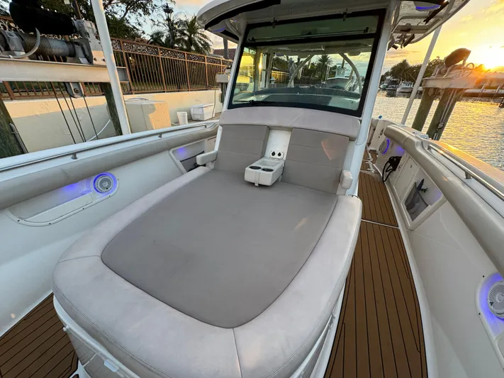  Yacht Photos Pics 2017 Boston Whaler 370 Outrage boat interior with cushioned seating and sunset view.