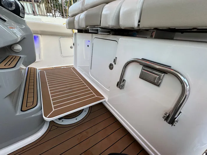  Yacht Photos Pics 2017 Boston Whaler 370 Outrage interior with teak flooring and seating area.