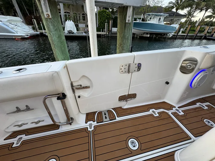  Yacht Photos Pics 2017 Boston Whaler 370 Outrage boat interior with teak flooring and dockside view.