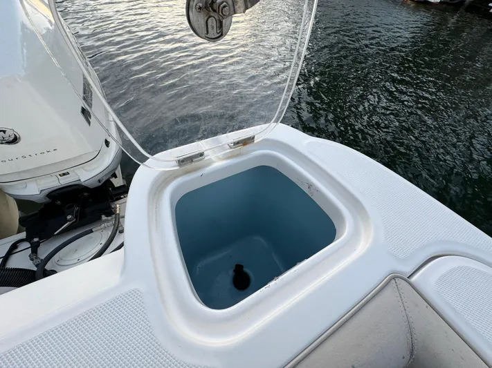  Yacht Photos Pics Open storage compartment on 2017 Boston Whaler 370 Outrage boat by the water.