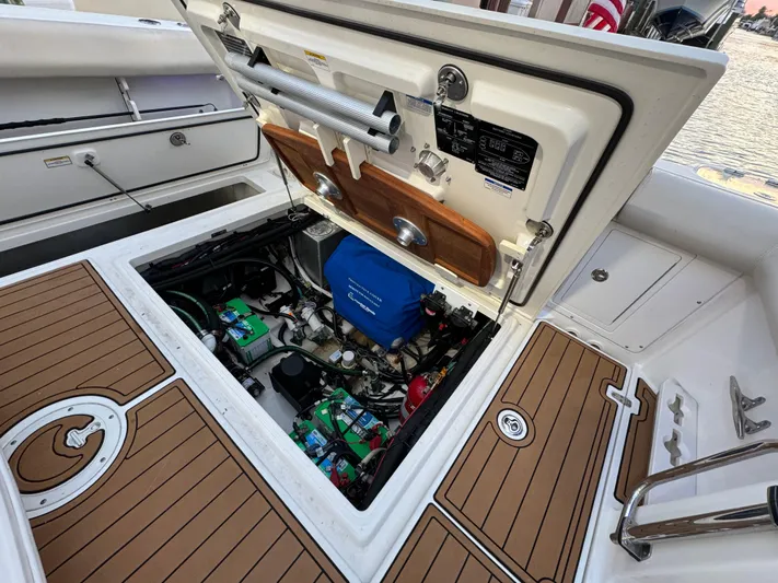  Yacht Photos Pics 2017 Boston Whaler 370 Outrage engine compartment with open hatch, showcasing internal components.