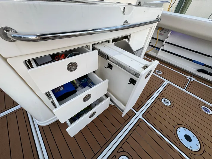  Yacht Photos Pics 2017 Boston Whaler 370 Outrage boat with open storage compartments on deck.