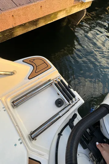  Yacht Photos Pics 2017 Boston Whaler 370 Outrage boat ladder near dock, close-up view.