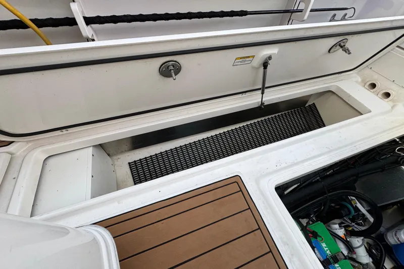  Yacht Photos Pics 2017 Boston Whaler 370 Outrage deck with storage compartment and fishing rod holders.