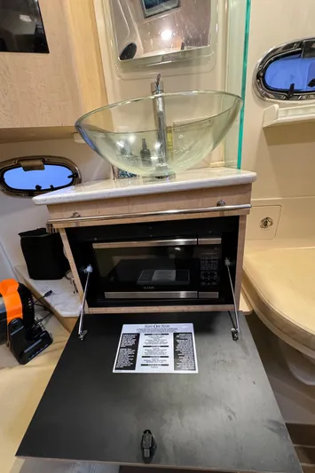  Yacht Photos Pics 2017 Boston Whaler 370 Outrage interior with sink and microwave setup.