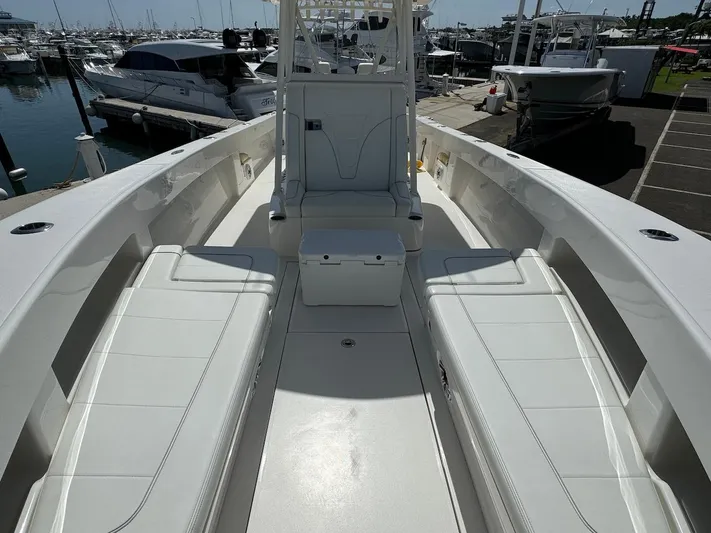  Yacht Photos Pics 2024 SeaVee 340Z boat interior with spacious seating and sleek design at a marina.