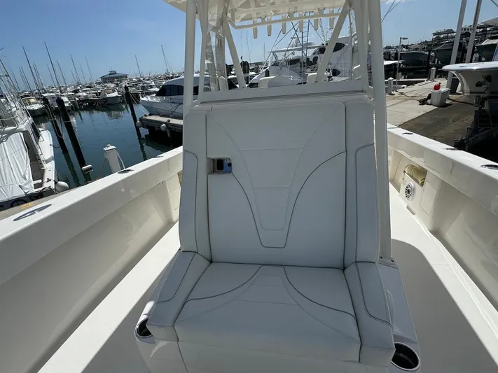  Yacht Photos Pics 2024 SeaVee 340Z boat with white seating, docked in a marina.