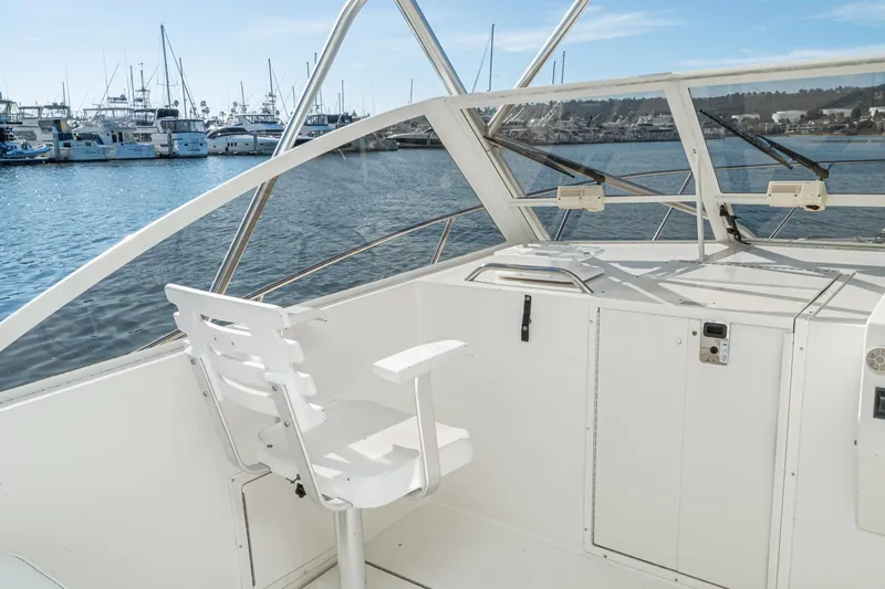 Jesses Girl Yacht Photos Pics 2005 Carolina Classic 28 boat interior with white seating, docked at marina.