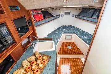Jesses Girl Yacht Photos Pics 2005 Carolina Classic 28 cabin interior with kitchenette and cozy seating area.