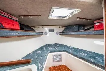 Jesses Girl Yacht Photos Pics 2005 Carolina Classic 28 cabin interior with life jackets and cozy sleeping area.