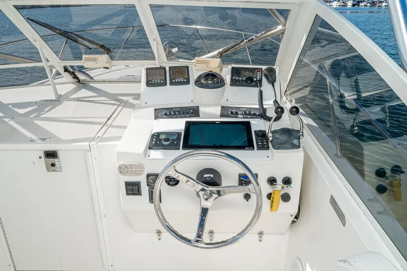 Jesses Girl Yacht Photos Pics Helm of 2005 Carolina Classic 28 boat with navigation equipment and steering wheel.