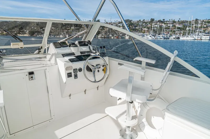 Jesses Girl Yacht Photos Pics 2005 Carolina Classic 28 boat helm with steering wheel and controls, docked in marina.