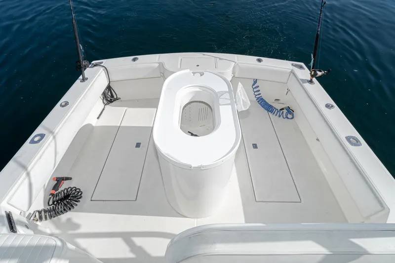 Jesses Girl Yacht Photos Pics 2005 Carolina Classic 28 boat deck with fishing equipment and storage compartments.